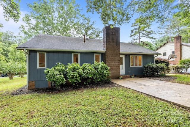 13446 Idlefield Ln, Matthews, NC 28105 - view of front of home featuring a chimney, a front lawn, and roof with shingles