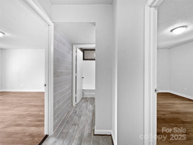 1908 Harvest Ln Unit 5, Charlotte, NC 28210 - hallway featuring a textured ceiling, wood finished floors, and baseboards