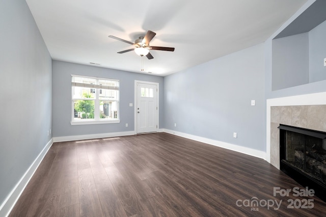207 Stoney Point Way, Candler, NC 28715 - unfurnished living room with ceiling fan, a tile fireplace, dark wood-type flooring, and baseboards
