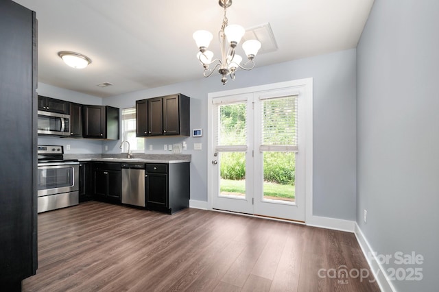 207 Stoney Point Way, Candler, NC 28715 - kitchen with stainless steel appliances, a sink, a chandelier, dark wood-style floors, and baseboards