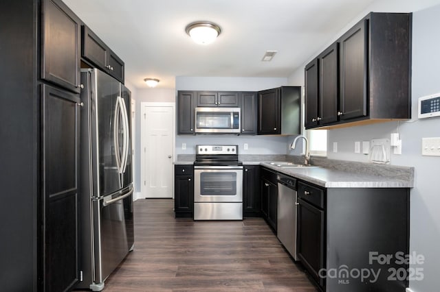 207 Stoney Point Way, Candler, NC 28715 - kitchen featuring stainless steel appliances, a sink, dark wood-style floors, and light countertops