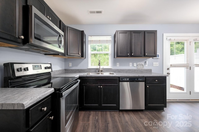 207 Stoney Point Way, Candler, NC 28715 - kitchen with stainless steel appliances, a sink, dark wood finished floors, and light countertops