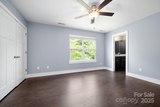 207 Stoney Point Way, Candler, NC 28715 - unfurnished bedroom with a sink, baseboards, dark wood-style flooring, and ensuite bath