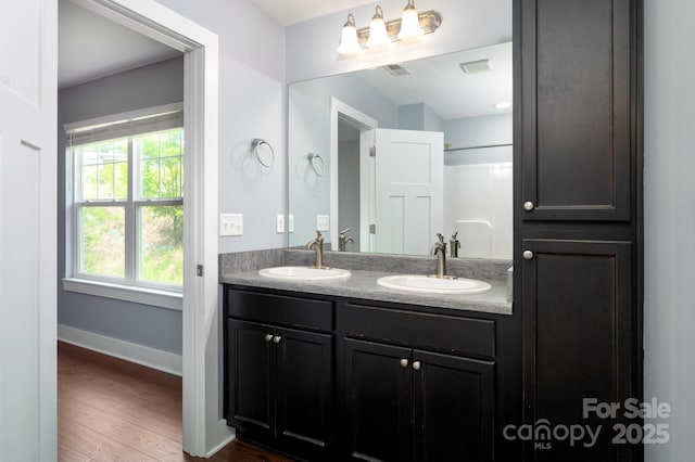 207 Stoney Point Way, Candler, NC 28715 - bathroom with double vanity, wood finished floors, and baseboards