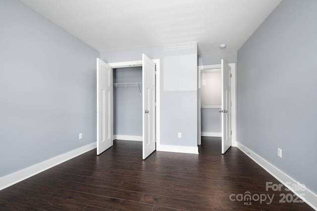 207 Stoney Point Way, Candler, NC 28715 - unfurnished bedroom featuring dark wood finished floors and baseboards