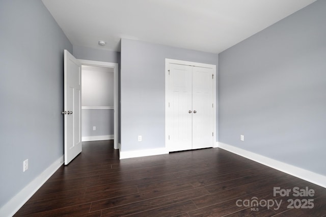 207 Stoney Point Way, Candler, NC 28715 - unfurnished bedroom with wood finished floors, baseboards, and a closet