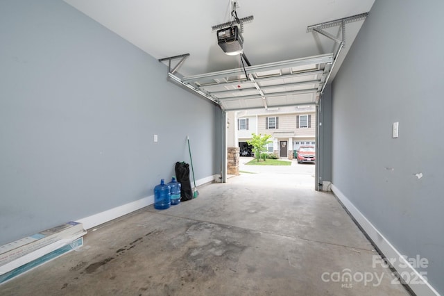 207 Stoney Point Way, Candler, NC 28715 - garage with a garage door opener and baseboards