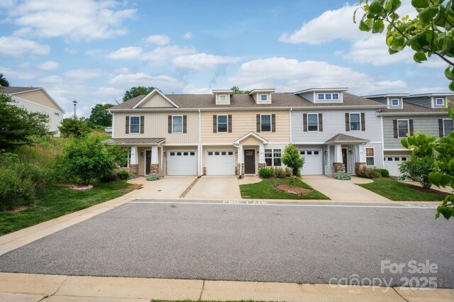 207 Stoney Point Way, Candler, NC 28715 - townhome / multi-family property featuring driveway, an attached garage, stone siding, and a shingled roof