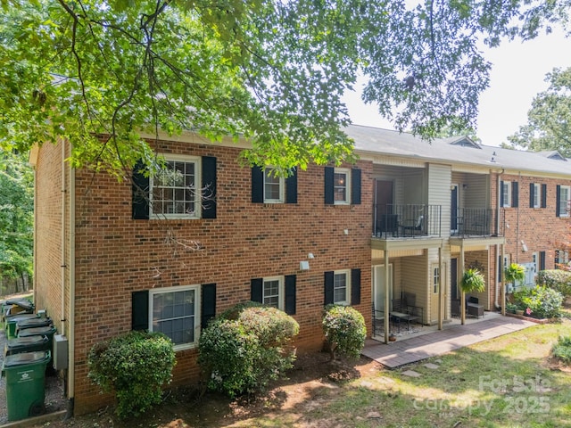 5927 Quail Hollow Rd Unit H, Charlotte, NC 28210 - back of house featuring a balcony, brick siding, and a patio area
