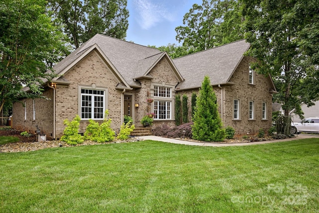 12900 Westmoreland Rd, Huntersville, NC 28078 - view of front of house featuring brick siding, a front yard, and a shingled roof