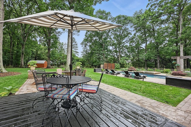 12900 Westmoreland Rd, Huntersville, NC 28078 - wooden terrace with an outdoor hot tub, outdoor dining area, a lawn, and view of wooded area