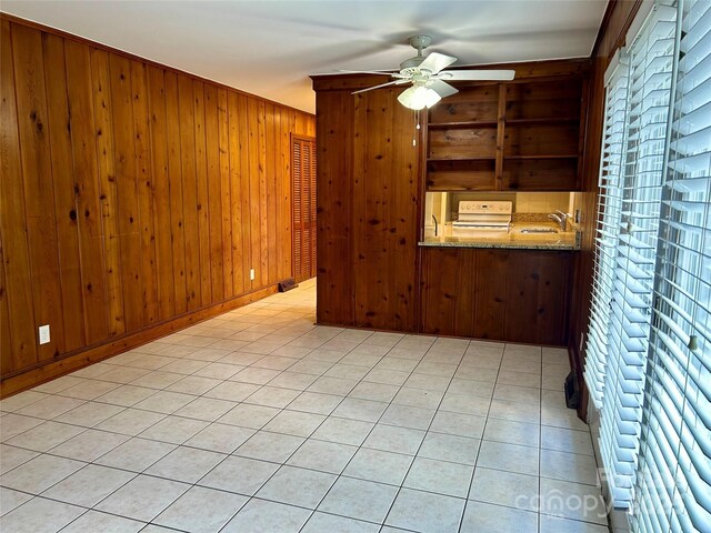 5734 Brookhaven Rd, Charlotte, NC 28210 - empty room with ceiling fan, wood walls, and a sink