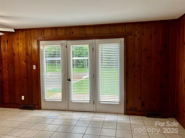 5734 Brookhaven Rd, Charlotte, NC 28210 - entryway featuring wood walls, light tile patterned floors, and french doors