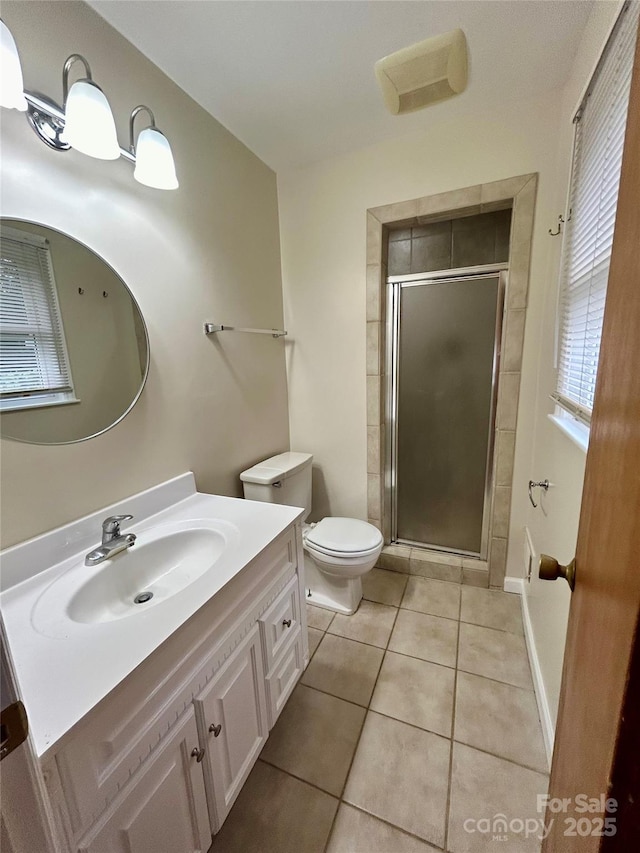 5734 Brookhaven Rd, Charlotte, NC 28210 - full bathroom with an enclosed shower, tile patterned floors, vanity, and toilet