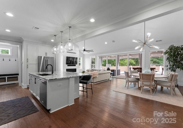 4021 Redwood Ave, Charlotte, NC 28205 - kitchen featuring a sink, appliances with stainless steel finishes, open floor plan, recessed lighting, and a kitchen island with sink