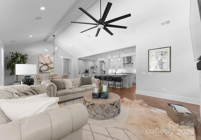 4021 Redwood Ave, Charlotte, NC 28205 - living room with beamed ceiling, a ceiling fan, light wood-style floors, baseboards, and recessed lighting