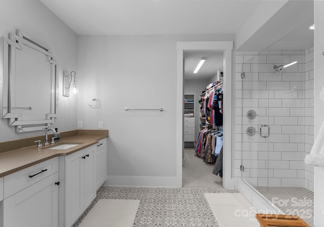4021 Redwood Ave, Charlotte, NC 28205 - full bathroom featuring a stall shower, vanity, a walk in closet, and baseboards