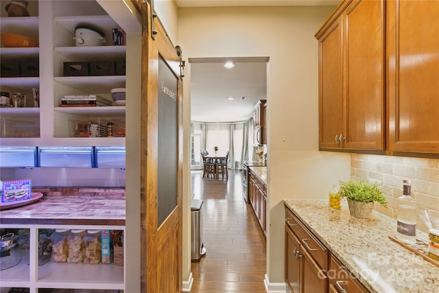 4430 Bravery Pl SW, Concord, NC 28027 - corridor with a barn door, wood finished floors, and recessed lighting