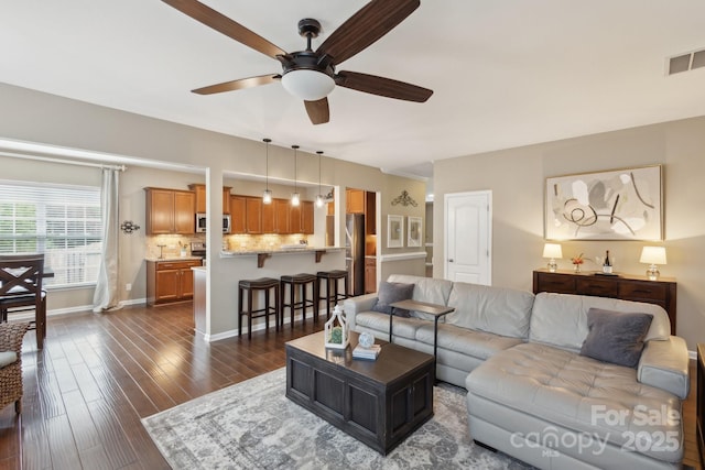 4430 Bravery Pl SW, Concord, NC 28027 - living area with ceiling fan, dark wood-style flooring, and baseboards
