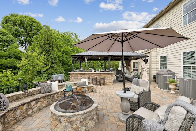 4430 Bravery Pl SW, Concord, NC 28027 - view of patio with a gazebo, an outdoor living space with a fire pit, and central AC