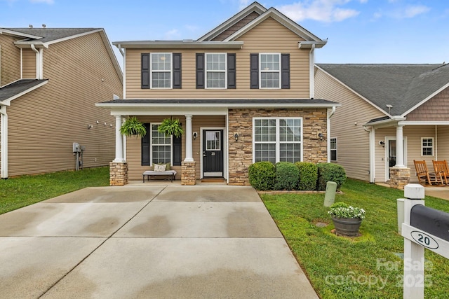 20 Daphne Dr, Arden, NC 28704 - view of front of property with covered porch, stone siding, and a front lawn