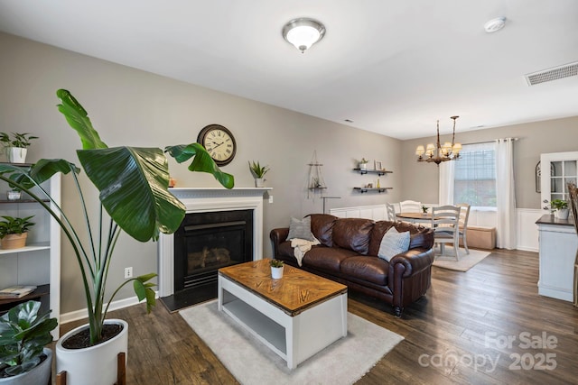 20 Daphne Dr, Arden, NC 28704 - living room featuring dark wood finished floors, a chandelier, and a glass covered fireplace