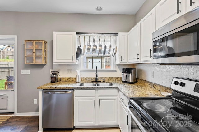 20 Daphne Dr, Arden, NC 28704 - kitchen with appliances with stainless steel finishes, a sink, baseboards, tasteful backsplash, and wood finished floors