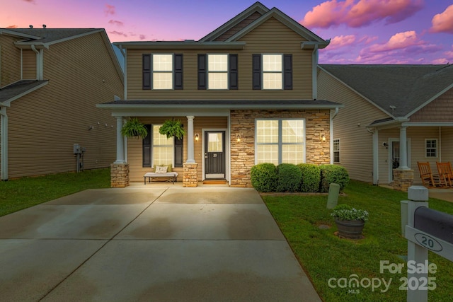 20 Daphne Dr, Arden, NC 28704 - view of front of house featuring covered porch, stone siding, and a front lawn