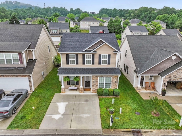 20 Daphne Dr, Arden, NC 28704 - traditional-style house featuring a porch, stone siding, roof with shingles, and a front lawn