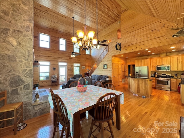658 Green Point Ln, Boomer, NC 28606 - dining space featuring high vaulted ceiling, a chandelier, wood walls, light wood finished floors, and wooden ceiling