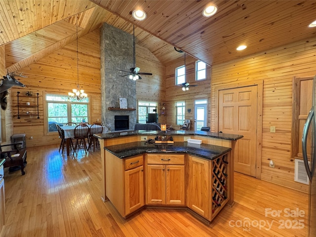 658 Green Point Ln, Boomer, NC 28606 - kitchen with high vaulted ceiling, open floor plan, a wooden ceiling with exposed beams, wood walls, and light wood-style floors