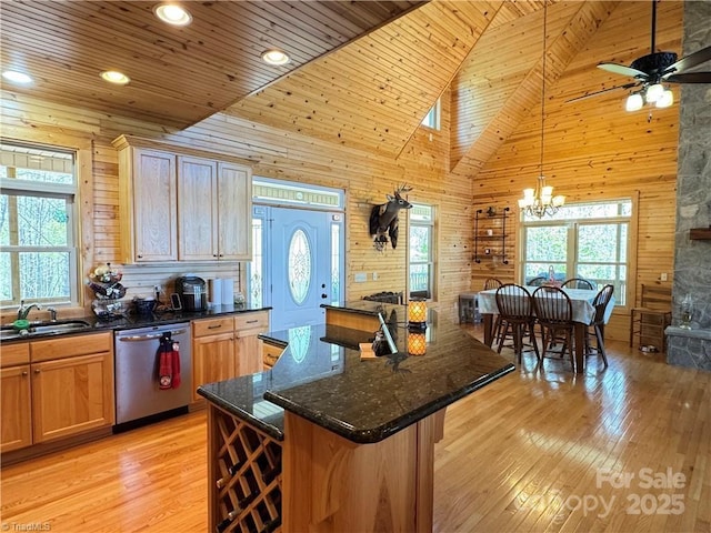 658 Green Point Ln, Boomer, NC 28606 - kitchen featuring stainless steel dishwasher, wood walls, healthy amount of natural light, ceiling fan, and light wood-style flooring