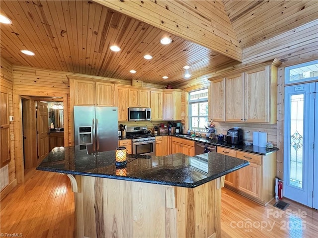 658 Green Point Ln, Boomer, NC 28606 - kitchen with appliances with stainless steel finishes, light wood-style floors, light brown cabinets, recessed lighting, and wood walls