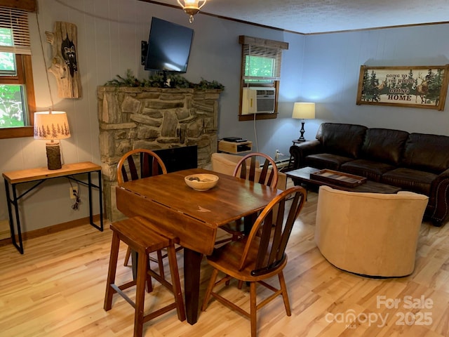 37 Sassafras Ln, Maggie Valley, NC 28751 - dining area with light wood-style flooring, a fireplace, and ornamental molding