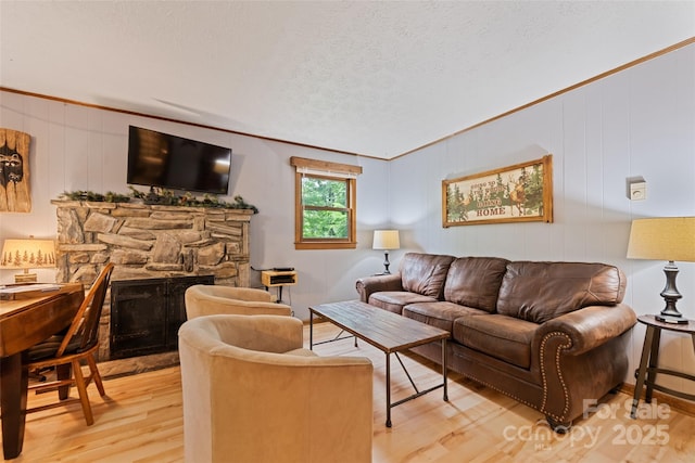 37 Sassafras Ln, Maggie Valley, NC 28751 - living area with light wood-type flooring, a fireplace, and crown molding