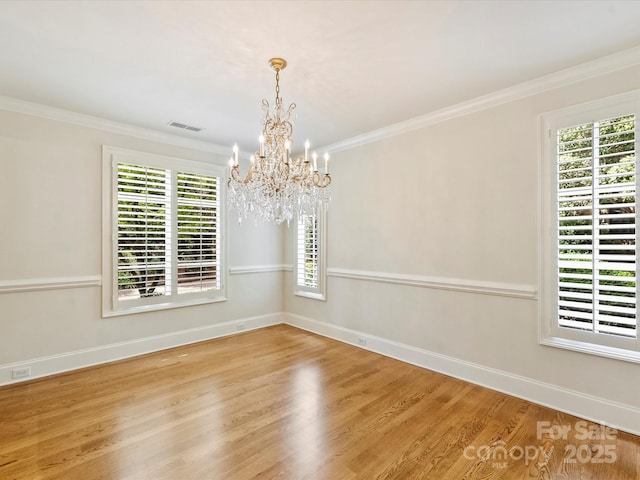 1522 High St, Charlotte, NC 28211 - spare room with a chandelier, wood finished floors, healthy amount of natural light, and ornamental molding