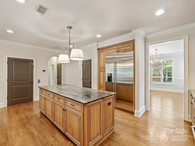 1522 High St, Charlotte, NC 28211 - kitchen featuring stainless steel built in fridge, a center island, arched walkways, light wood-type flooring, and crown molding