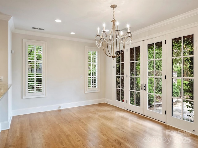 1522 High St, Charlotte, NC 28211 - unfurnished dining area featuring plenty of natural light, crown molding, light wood-type flooring, baseboards, and a chandelier