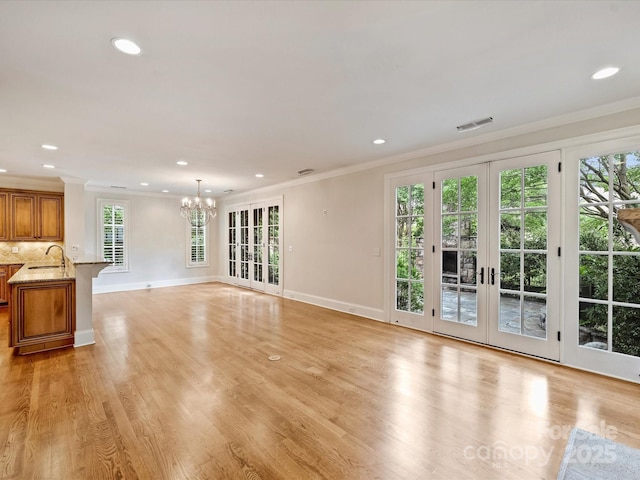 1522 High St, Charlotte, NC 28211 - unfurnished living room with a sink, crown molding, a chandelier, recessed lighting, and baseboards