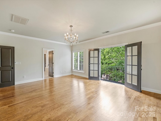 1522 High St, Charlotte, NC 28211 - empty room featuring a chandelier, baseboards, wood finished floors, and ornamental molding