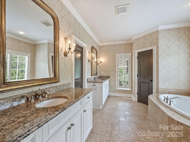 1522 High St, Charlotte, NC 28211 - bathroom featuring two vanities, a garden tub, ornamental molding, and stone tile floors