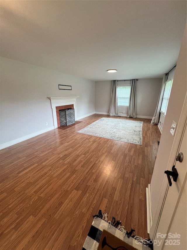 800 Charles Rd, Shelby, NC 28150 - unfurnished living room with wood finished floors, a fireplace, and baseboards