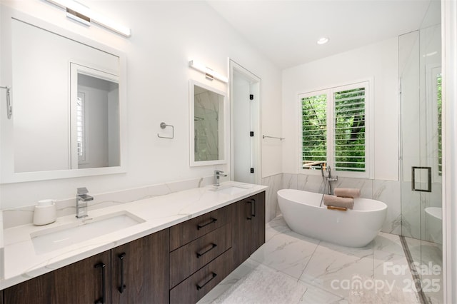 5925 Creola Rd, Charlotte, NC 28270 - bathroom with tile walls, double vanity, a soaking tub, marble finish flooring, and wainscoting