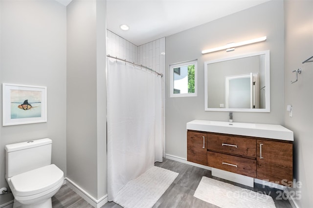 5925 Creola Rd, Charlotte, NC 28270 - bathroom with vanity, wood finished floors, toilet, and a shower with shower curtain