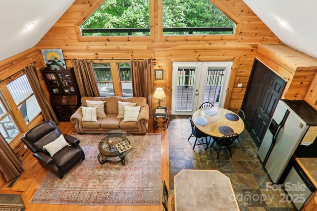 145 Jobes Trl, Mill Spring, NC 28756 - living area featuring healthy amount of natural light, high vaulted ceiling, french doors, wood finished floors, and wood walls