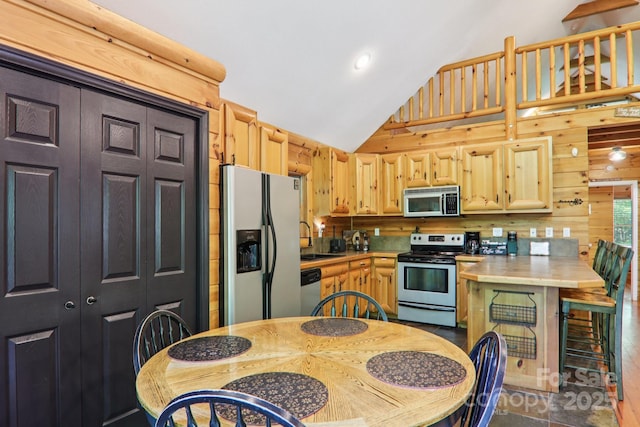 145 Jobes Trl, Mill Spring, NC 28756 - kitchen featuring stainless steel appliances, light countertops, light brown cabinetry, wood walls, and a peninsula