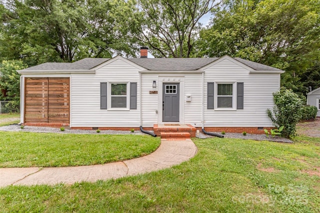 2601 Ashley Rd, Charlotte, NC 28208 - view of front facade with crawl space, a shingled roof, and a front lawn