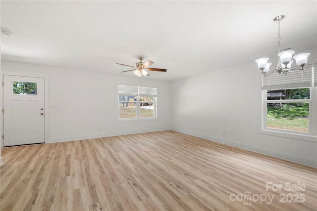 208 N Correll St, Landis, NC 28025 - unfurnished living room with plenty of natural light, light wood-style flooring, baseboards, and a chandelier