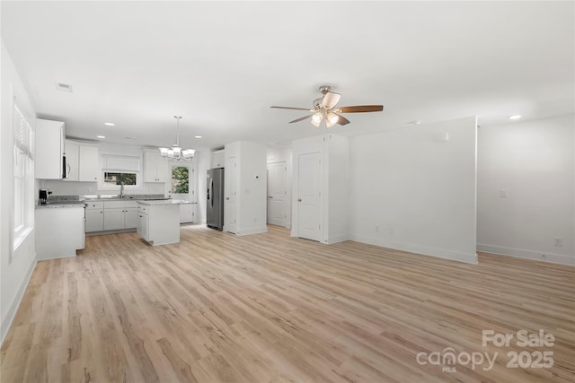 208 N Correll St, Landis, NC 28025 - unfurnished living room featuring a ceiling fan, a chandelier, light wood-style floors, recessed lighting, and baseboards