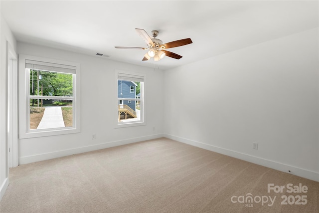 208 N Correll St, Landis, NC 28025 - spare room with healthy amount of natural light, light carpet, baseboards, and ceiling fan